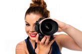 wdnetstudio Photographer occupation concept - beautiful and attractive woman holding a professional DSLR camera and smiling