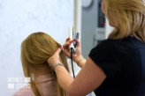 wdnetstudio Professional services in the beauty salon - a young woman with beautiful blond hair has made hairstyles with a curling iron.