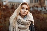 Alonesdj Beautiful young woman in a warm scarf standing in autumn park.