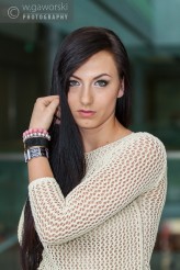 wzrokowiec young attractive woman touching her hair in business lobby