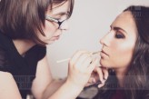 wdnetstudio Makeup artist performs professional model's make-up before a photo shoot.