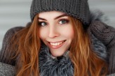 Alonesdj Beautiful happy young woman with a smile in the winter knitted hat and mittens vintage.